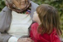 2114340-great-grandmother-and-child-sitting-on-a-bench-in-the-park-and-looking-at-each-other